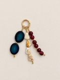 Beaded Bag Charm with blue oval beads, red round beads, marbled cream beads and a gold-tone ring clasp