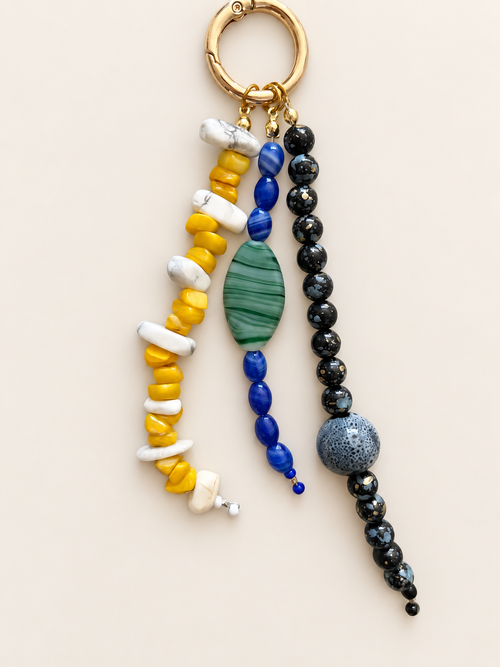 Yellow Blue Black Triple Strand beaded bag charm with yellow and white, blue with green, and glossy black strands, plus gold-tone clip
