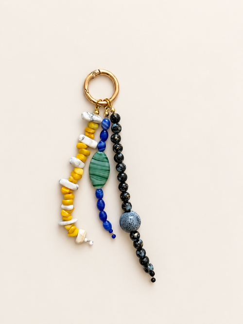 Yellow Blue Black Triple Strand beaded bag charm with yellow and white, blue and green-striped, and black bead strands on a gold-tone clip